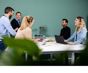 A group of Associates talking during a meeting